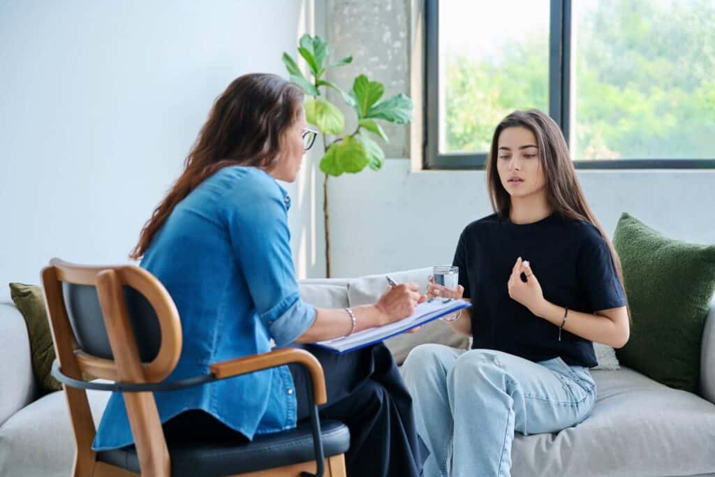 Woman talking to her counselor about eating disorder treatment statistics.