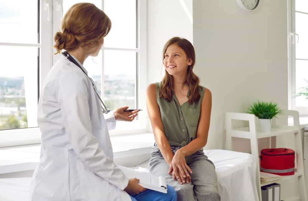 Young girl talking to doctor at eating disorders in pediatrics.